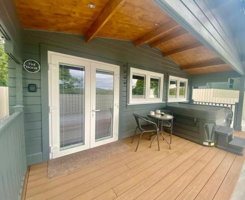 a screened in porch with a desk and a table at Mill Farm Retreat in Gortin