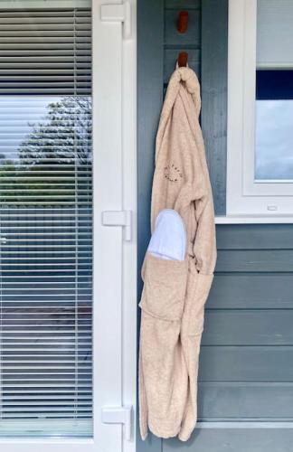a towel hanging on the side of a house at Mill Farm Retreat in Gortin