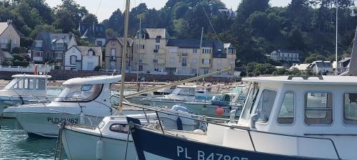 a group of boats docked in a harbor with buildings at Appartement La Plage Plouha in Plouha