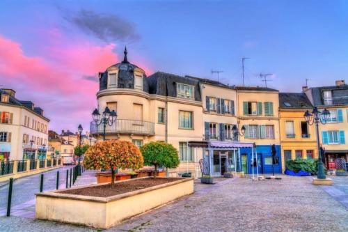 a street in a city with a building at Le Royal Billy in Dreux