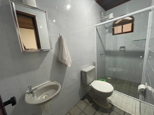 a bathroom with a toilet and a sink and a shower at Recanto do Abraao in Abraão