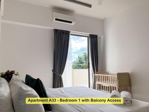 a bedroom with a bed and a window with a view at By the Sea- Pool and Sea View in Batu Ferringhi