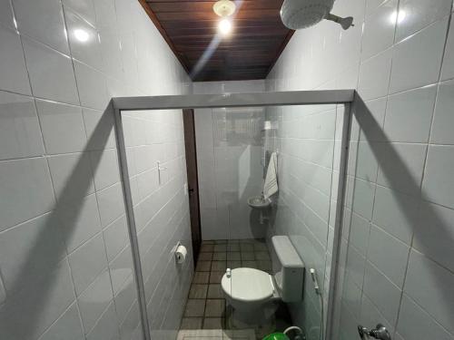 a small bathroom with a toilet in a stall at Recanto do Abraao in Abraão
