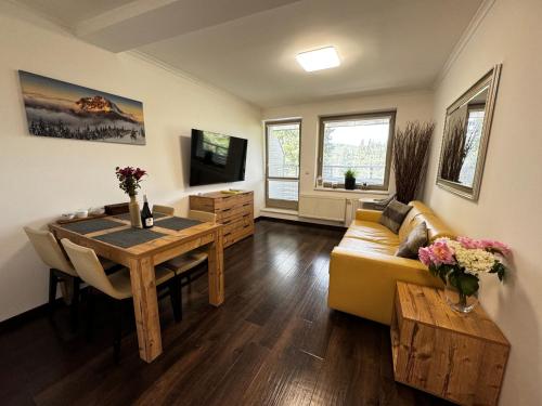 a living room with a couch and a table at Mountain Apartment Resident - relax s wellness, terasou a soukromou garáží in Harrachov