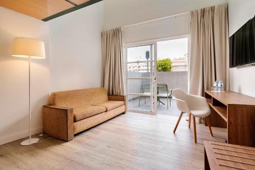 a living room with a couch and a table at Alua Atlantico Golf - All Inclusive in San Miguel de Abona