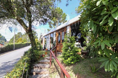 a house on the side of a street at Pousada Campos do Jordao Suites in Campos do Jordão