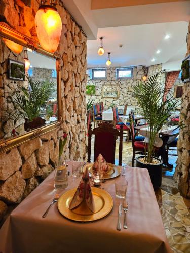 a table with two plates of food on it in a restaurant at Hotel Galicja SPA Wieliczka in Wieliczka