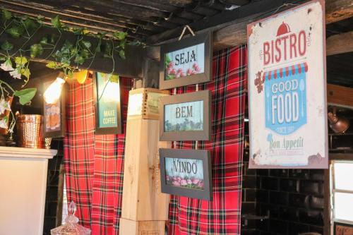 a restaurant with plaid walls and signs on the wall at Pousada Campos do Jordao Suites in Campos do Jordão