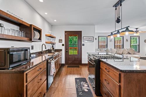 a kitchen with wooden cabinets and a counter top at Utopian Bliss in Sevierville