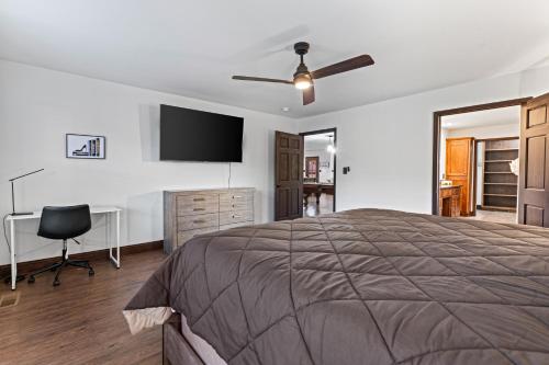 a bedroom with a bed and a flat screen tv at Utopian Bliss in Sevierville