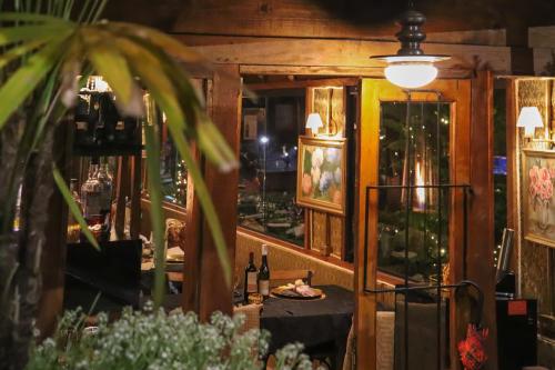 a dining room with a table and a mirror at Pousada Campos do Jordao Suites in Campos do Jordão