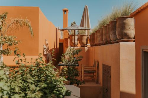 a courtyard with a chair and some plants at Dar Akal in Marrakech
