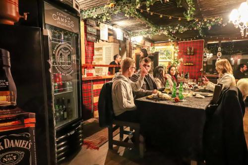 a group of people sitting at a table in a restaurant at Pousada Campos do Jordao Suites in Campos do Jordão