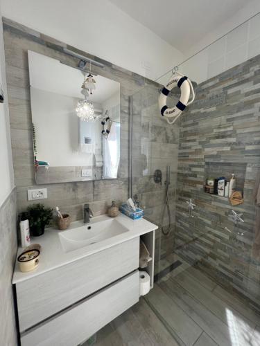 a bathroom with a sink and a shower at Appartamenti Bellavista 107 in Chioggia