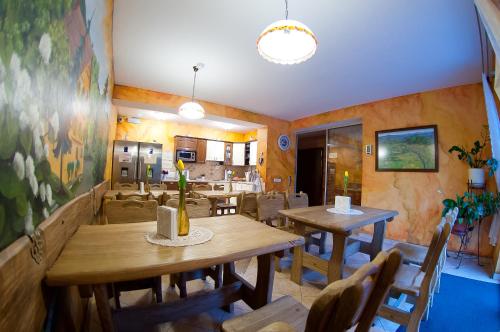 a dining room with wooden tables and chairs at Willa pod Czantorią SPA Ustroń in Ustroń