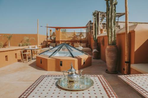 a terrace with a table and a view of the desert at Dar Akal in Marrakech