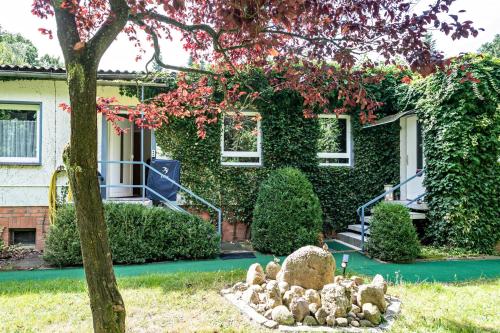 a house with a bunch of rocks in front of it at Ferienwohnung am Wald in Hagenow