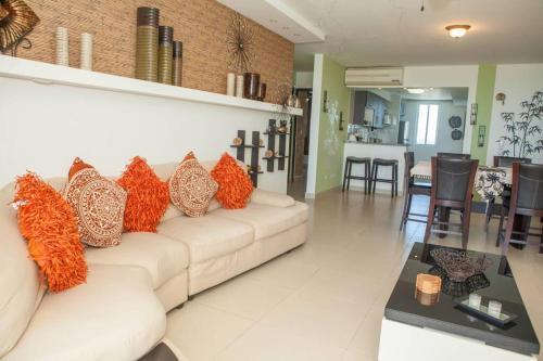 a living room with a white couch with colorful pillows at Beach Side Escape-Playa Blanca in Río Hato
