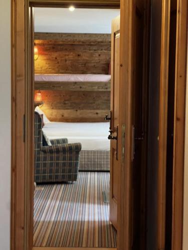 a view of a bedroom from a door with a bed at Hotel Berghof in Zermatt