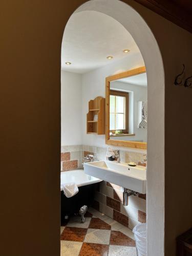 a bathroom with a sink and a mirror at Hotel Berghof in Zermatt