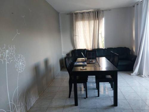 a living room with a table and a couch at Mountain View Haven, Port Louis in Port Louis
