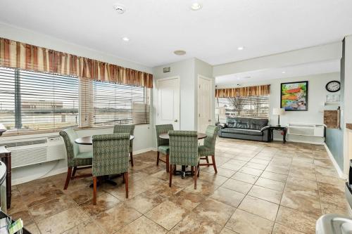 a living room with a table and chairs and a couch at Grove City Travel Inn South Columbus in Grove City