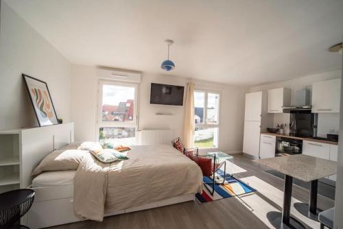 une chambre blanche avec un lit et une cuisine dans l'établissement Suite POP 92 proche gare, stade de France, Parking, à Osny