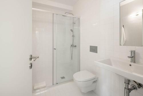 a bathroom with a shower and a toilet and a sink at Azul Downtown Apartments in Coimbra