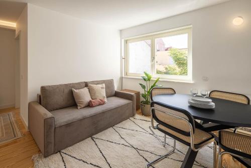 a living room with a couch and a table at Azul Downtown Apartments in Coimbra