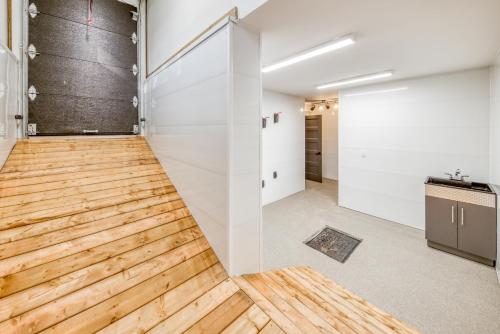 a room with a wooden floor and white walls at Les Chalets Immersion in Saint-Raymond