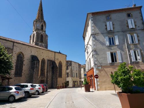 a city street with cars parked in front of a church at 2 Bed House with Mountain View Garden and Bbq in Confolens