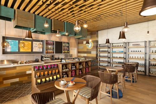 a restaurant with tables and chairs and wine bottles at Margaritaville Island Reserve Riviera Maya - An Adults Only Karisma All-Inclusive Experience in Puerto Morelos