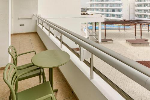 a balcony with a table and chairs on a building at Alua Atlantico Golf - All Inclusive in San Miguel de Abona