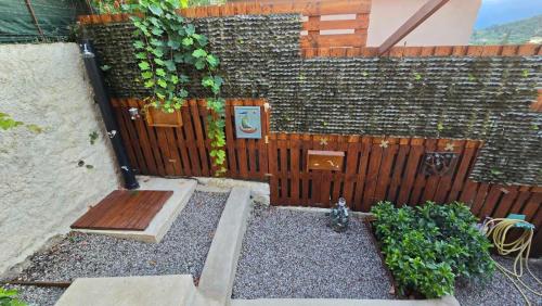 a wooden fence with a bench and some plants at Konti villa in Kondáraina