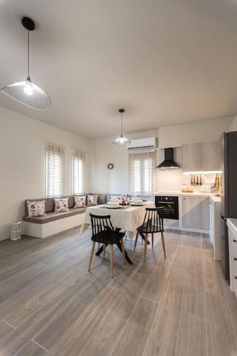 a kitchen and living room with a table and chairs at Aggelika's House in Batsi