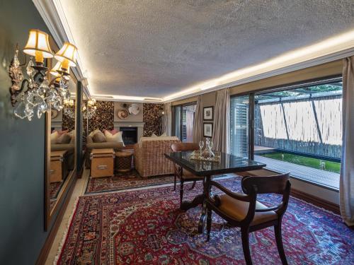 a living room with a table and a couch at The Residence in Johannesburg