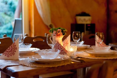 a wooden table with plates and wine glasses at Willa pod Czantorią SPA Ustroń in Ustroń