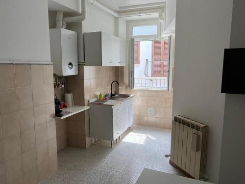 a small kitchen with a sink and a window at james house blu in Teramo