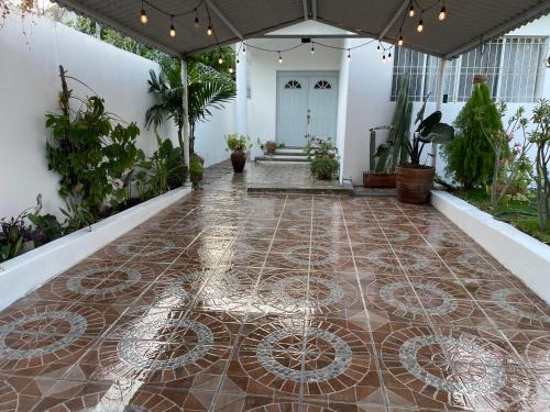 a hallway with a tile floor in a house at Casa Maya en el mejor lugar de Puerto Escondido in Puerto Escondido