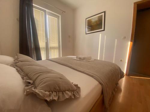 a bed in a room with a window at Guest House Regina Mundi in Međugorje