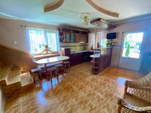 a kitchen and dining room with a table and chairs at Відпочинок в Карпатах in Nizhne-Studënyy