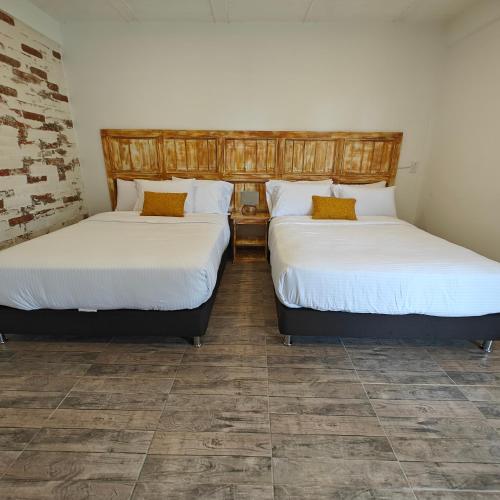 two beds sitting next to each other in a room at Zenith Bed & Breakfast in Pereira