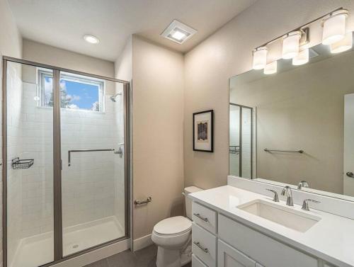 a bathroom with a toilet and a shower and a sink at Rendezvous - 99 Stagecoach in Fraser