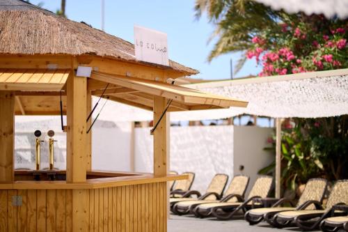 a gazebo with chairs and a sign on it at Alua Golf Trinidad in Roquetas de Mar