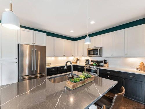 a kitchen with a sink and a stainless steel refrigerator at Rendezvous - 99 Stagecoach in Fraser