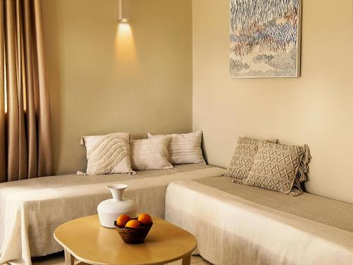 a living room with two beds and a table at Agali Hotel Paxos in Gaios