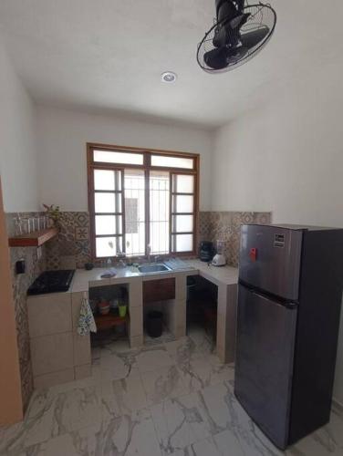 a kitchen with a refrigerator and a counter top at Departemento El tuch in Campeche