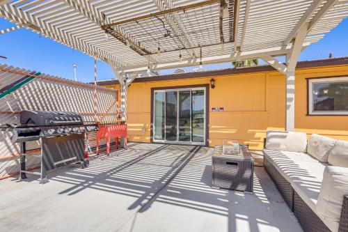 a pergola on a patio with a couch and a table at Yucca Valley Oasis with Hot Tub, Near Joshua Tree! in Yucca Valley