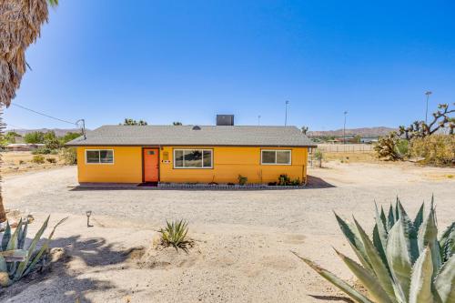 a yellow house in the middle of a desert at Yucca Valley Oasis with Hot Tub, Near Joshua Tree! in Yucca Valley