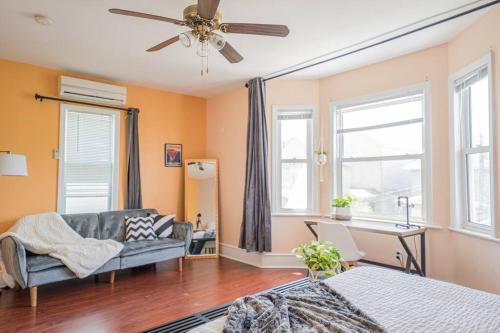 a living room with a couch and a ceiling fan at 7BR 7BA Big House 1 block from Tropicana and Beach in Atlantic City